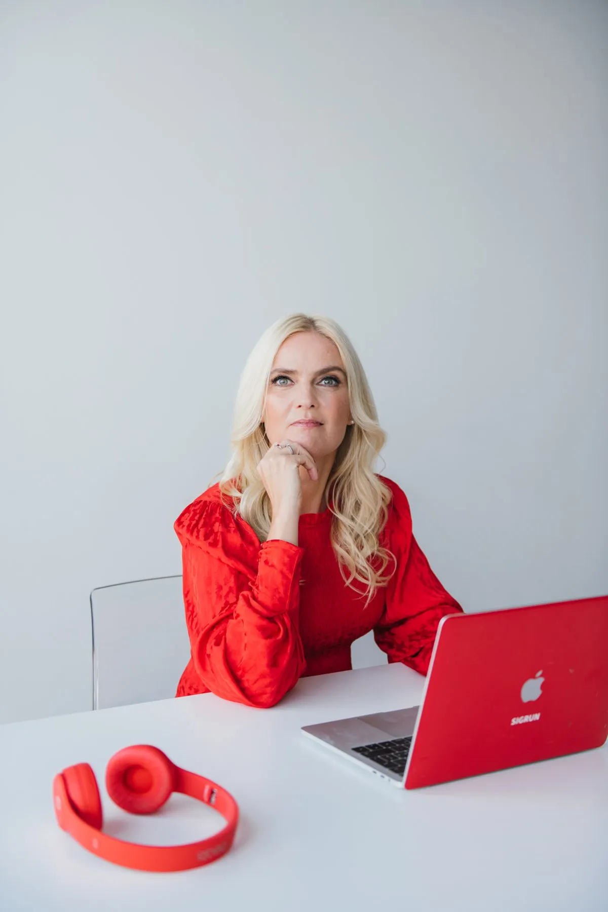 Sigrun at her desk with her red laptop, thinking