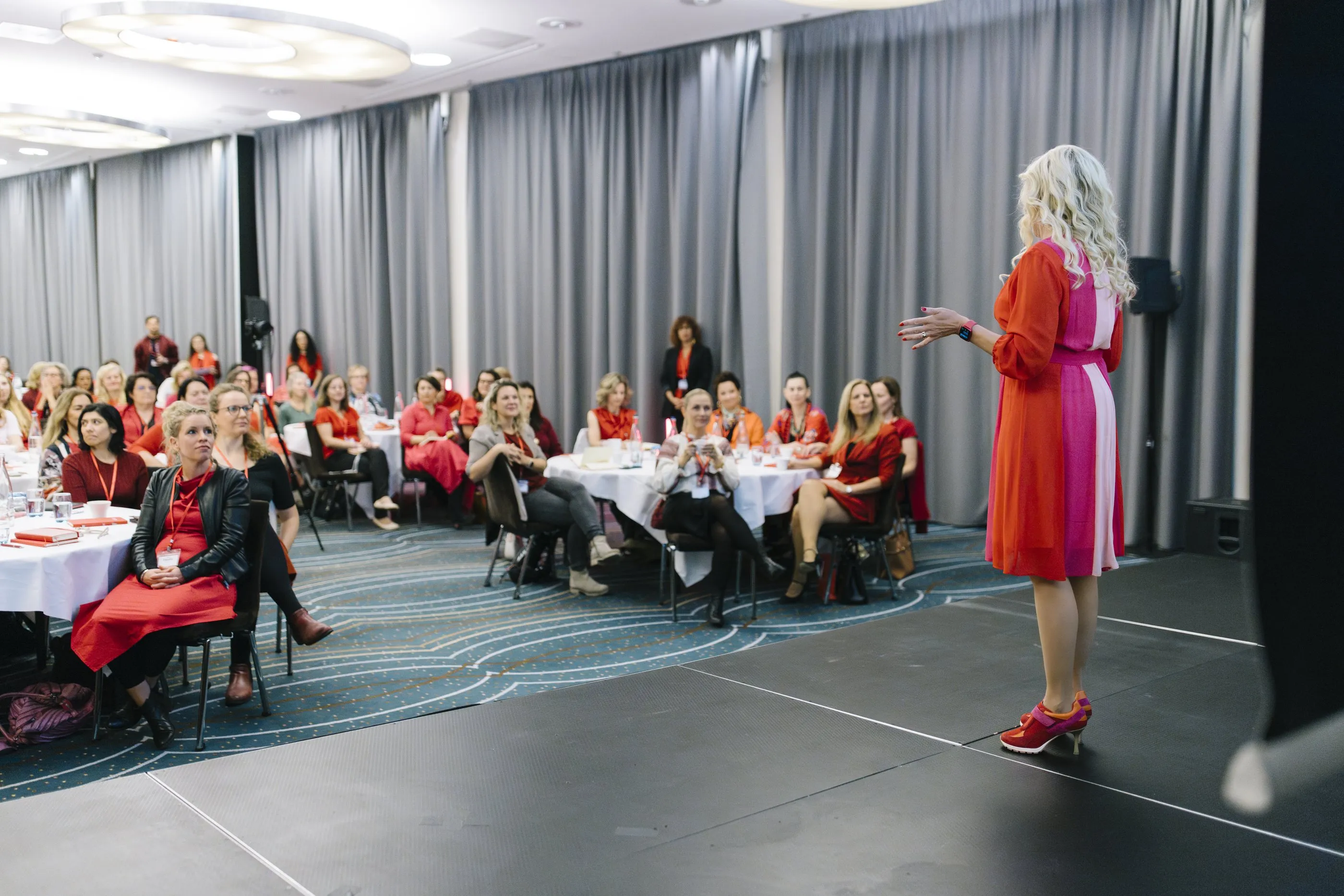Sigrun on stage talking to a full room at SIGRUN Live 2025