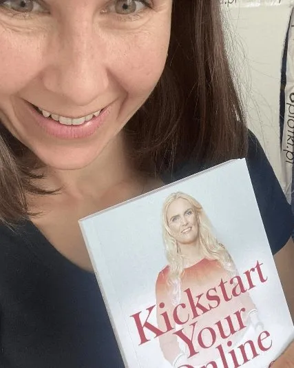 A reader holding Kickstart Your Online Business