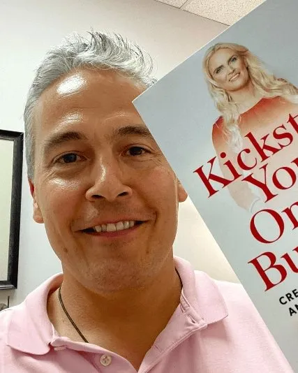 A reader holding Kickstart Your Online Business