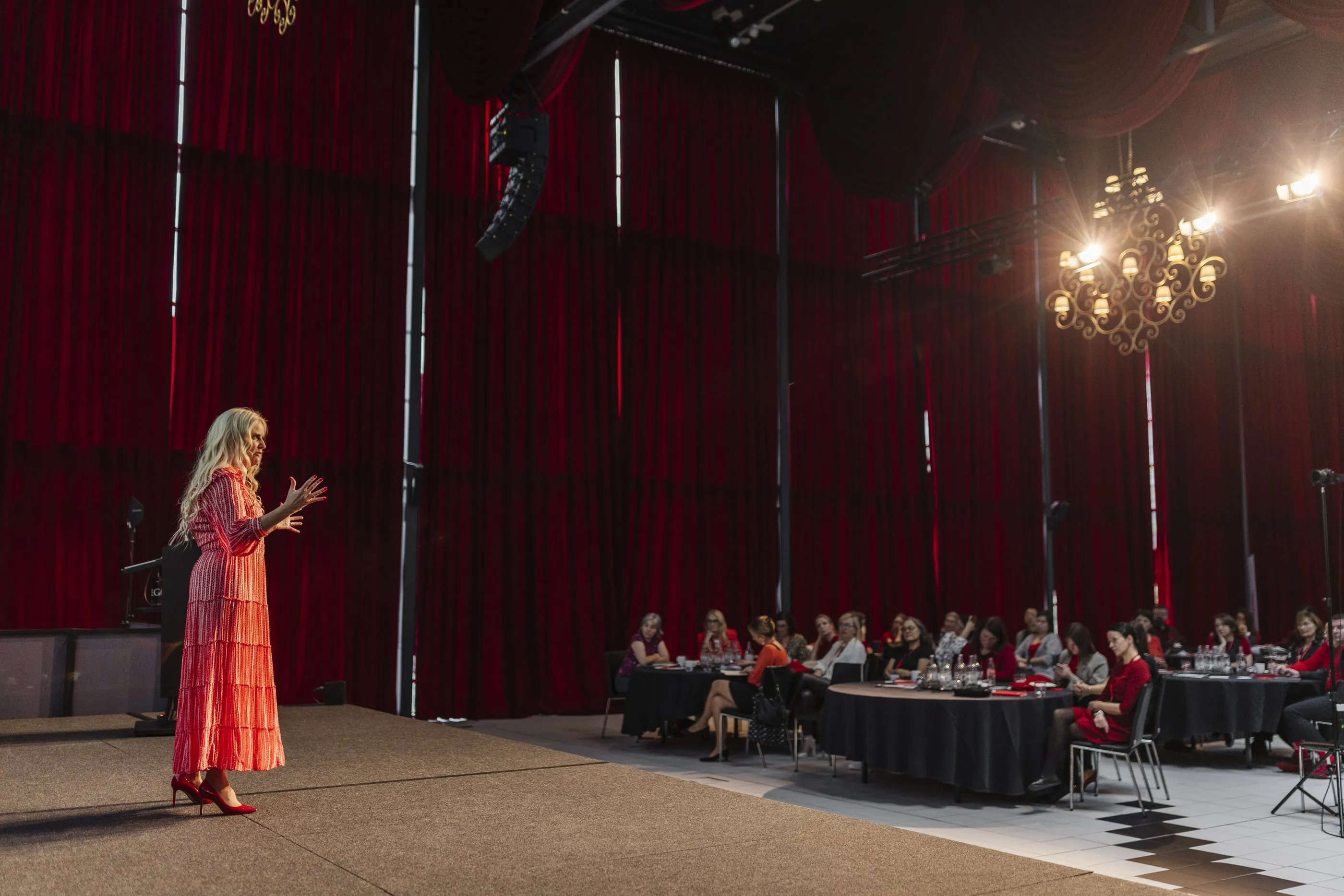 Sigrun speaking on stage to a full room at SIGRUN Live 2024