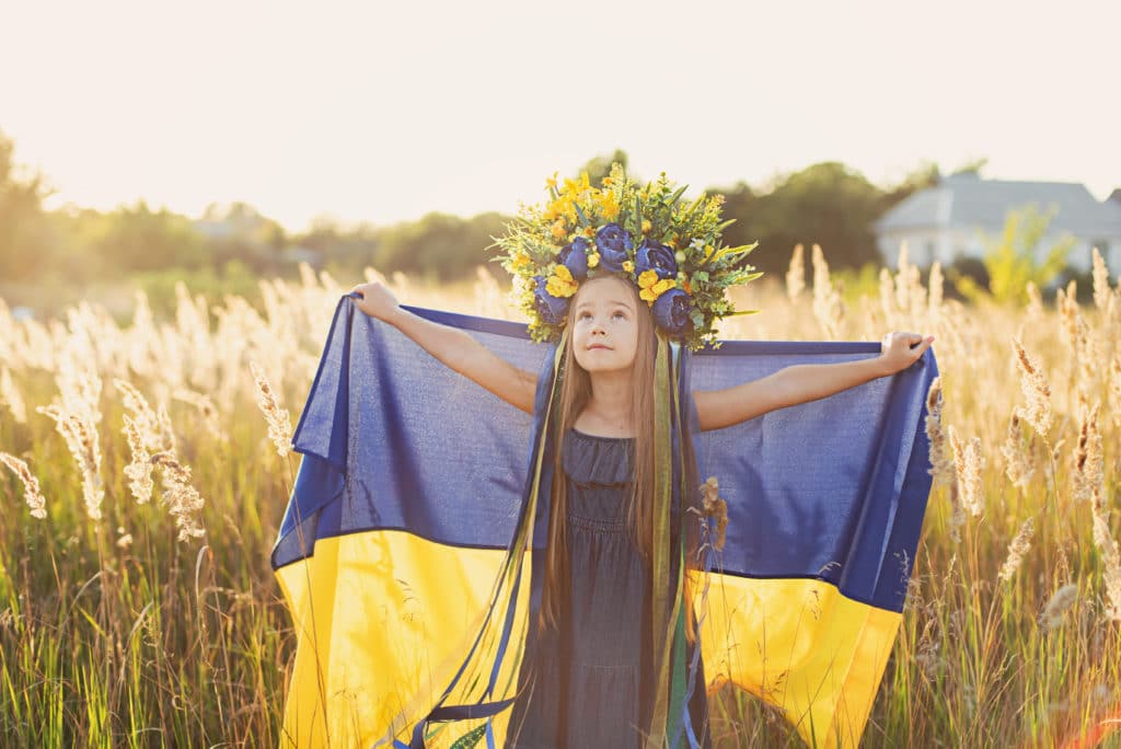 Ukrainian girl carrying the Ukrainian flag
